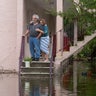 Ken and Tina Kruse stand next to their apartment after the area flooded from Hurricane Idalia