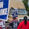 UAW Strikers slow a truck from entering the Ford Michigan Assembly Plant