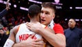 Bogdan Bogdanovic #13 hugs Dejounte Murray #5 of the Atlanta Hawks at the conclusion of the Atlanta Hawks 106-104 victory over the Orlando Magic at State Farm Arena on January 17, 2024 in Atlanta, Georgia.