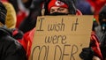 A Kansas City Chiefs fan holds a sign about the cold weather Saturday at GEHA Field at Arrowhead Stadium.