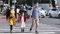 Parents with their kid walk along the Streets of Beijing.
