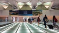 Passengers pull their rolling suitcases across a lighted glass bridge at Dulles International Airport in Dulles, Virginia, on Sept. 24, 2016.