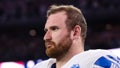 Frank Ragnow #77 of the Detroit Lions looks on from the sideline during the national anthem prior to an NFL football game against the Dallas Cowboys at AT&amp;amp;T Stadium on December 30, 2023 in Arlington, Texas.