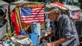 Douglas Bue, 65, pushes his wheelchair to his tent next to a homeless encampment outside the West L.A. Veterans Affairs facilities on Monday, Aug. 30, 2021.