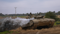 An Israeli army tank moves near the Israeli-Gaza border in southern Israel on Wednesday, Jan. 17.