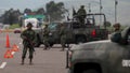 Soldiers stand guard at a checkpoint on an highway in Contepec in Mexico's Michoacan state in July 2015.