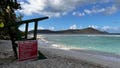 Safety sign with Park rules near Empty Lifeguard chair at Smith Bay beach, St Thomas, US Virgin Islands.