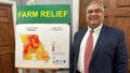 Missouri Treasurer Vivek Malek stands near a poster promoting drought conditions and state aid programs on Jan. 4, 2024, at his Capitol office in Jefferson City, Mo. Agricultural entities are among several categories of businesses that can receive low-interest loans backed by deposits of state funds made by the treasurer's office. Participation in such programs has grown in various states.