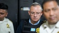 Former Guatemalan Interior Minister Napol&eacute;on Barrientos is escorted by police while awaiting a court hearing in Guatemala City, Thursday, Jan. 11, 2024.