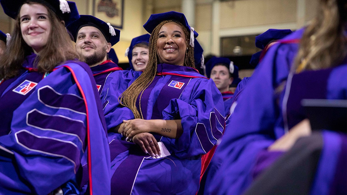Student smiling at American University graduation