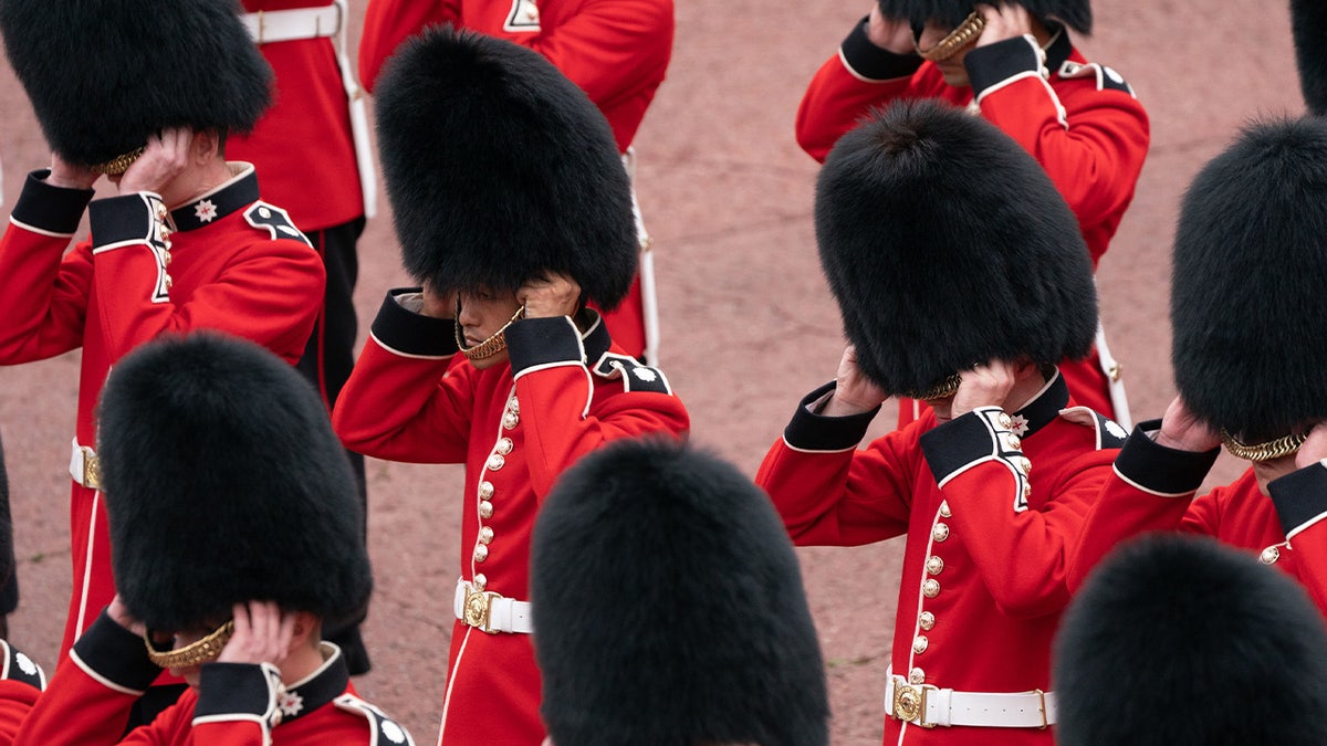 The King's Guard remove their Bearskin hats