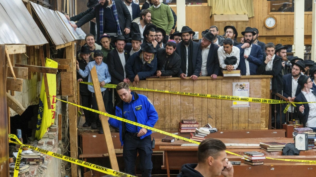 Jewish students watch as police hold perimeter around a Brooklyn synagogue