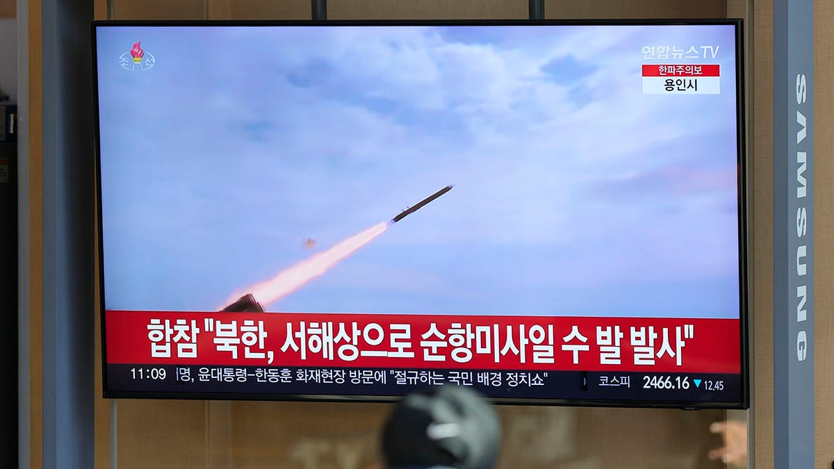 A photo of a missile in flight on TV