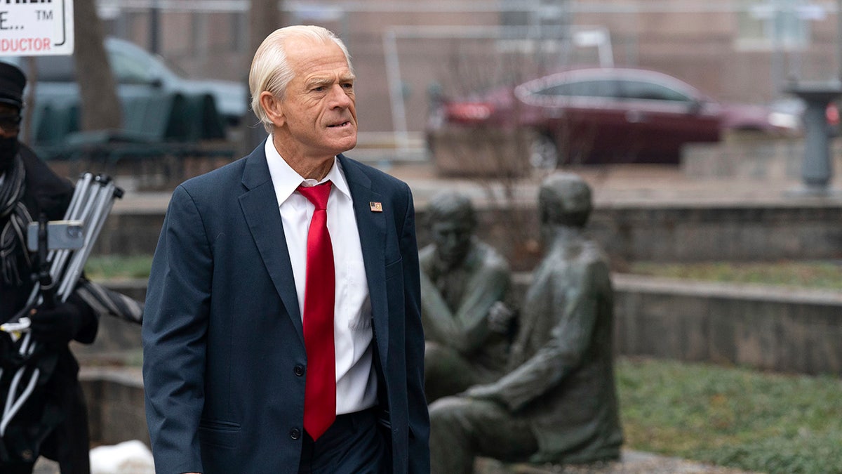 Peter Navarro in coat, red tie, arriving at courthouse