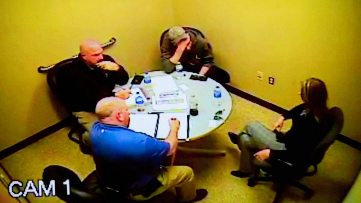 Police footage of James Crumbley, top center, and his wife, Jennifer, right, as they are interviewed by Oakland County Sheriff deputies after their son, Ethan Crumbley, shot and killed four students at Oxford High School on Nov. 30, 2021, is displayed Monday, Jan. 29, 2024, in an Oakland County courtroom, in Pontiac, Mich., during the trial of Jennifer, who is charged with involuntary manslaughter.