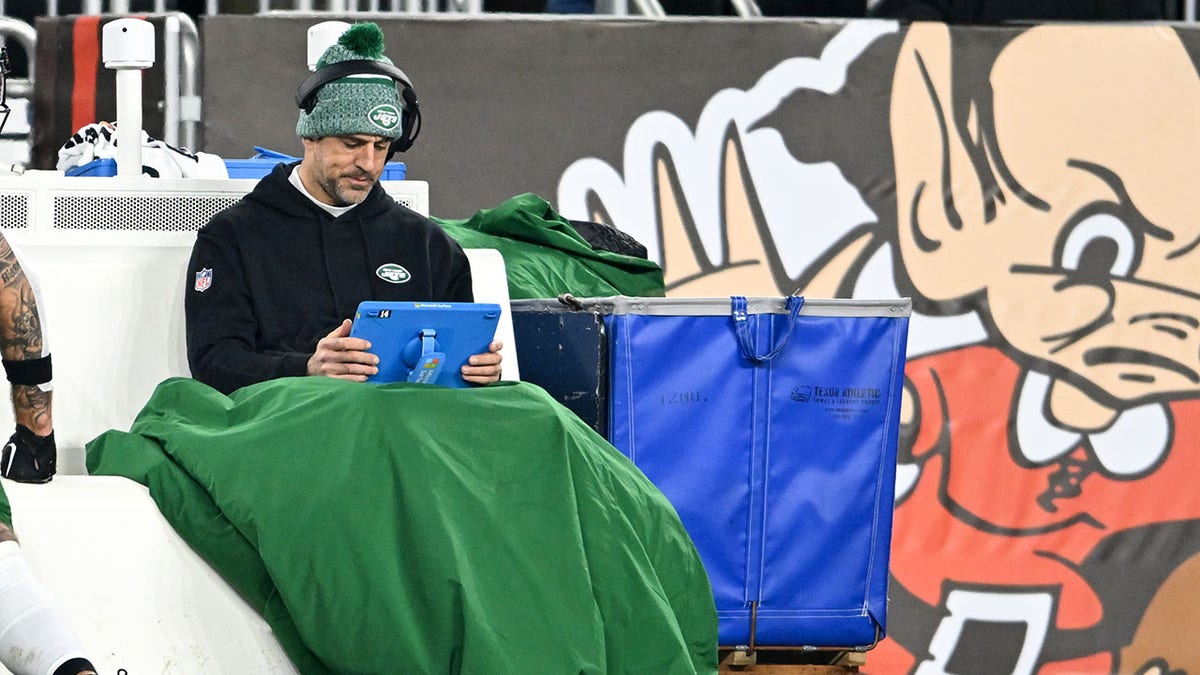 Aaron Rodgers looks at his tablet