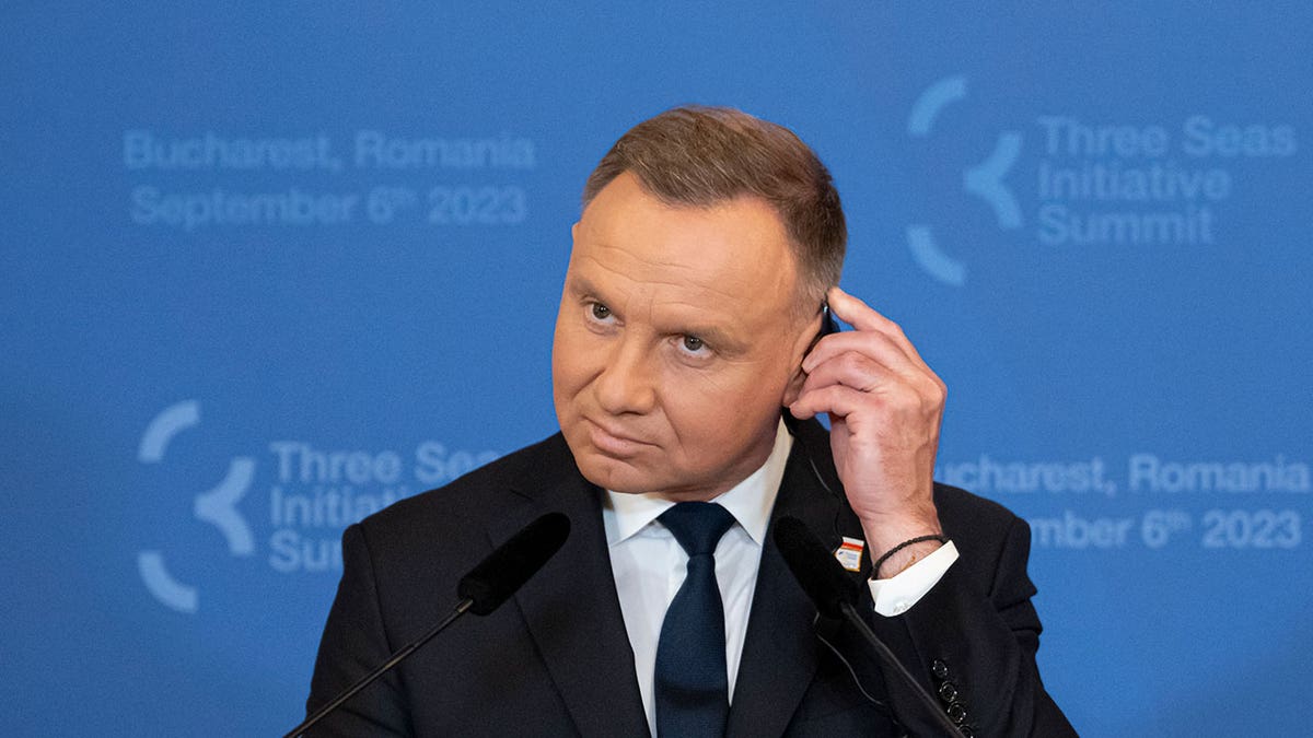 Andrzej Duda adjusts headphones