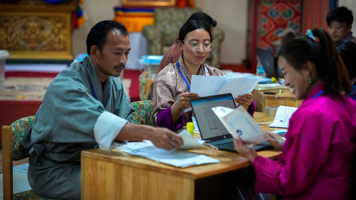 Election officials sort ballots