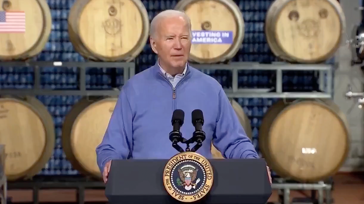 Biden speaking in Wisconsin, barrels behind him