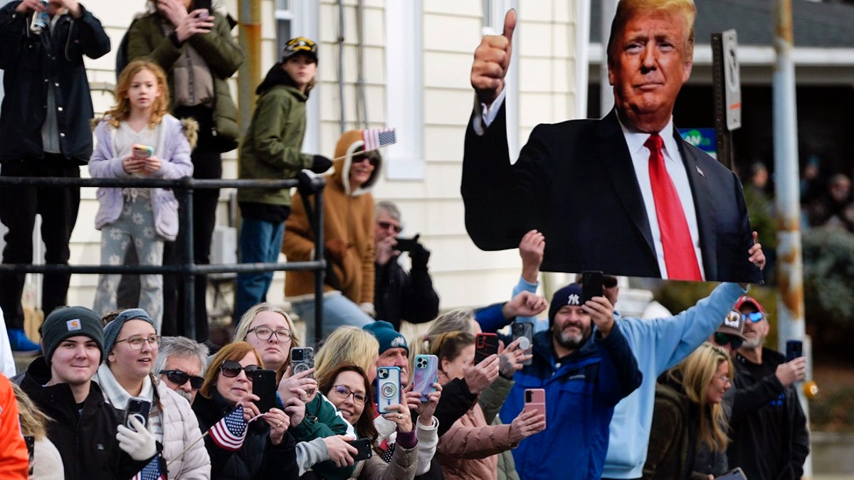 A spectator holds an image of former President Trump in Allentown