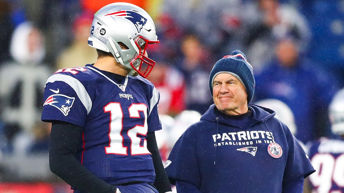 Tom Brady #12 talks to head coach Bill Belichick of the New England Patriots before a game against the Dallas Cowboys at Gillette Stadium on November 24, 2019 in Foxborough, Massachusetts.