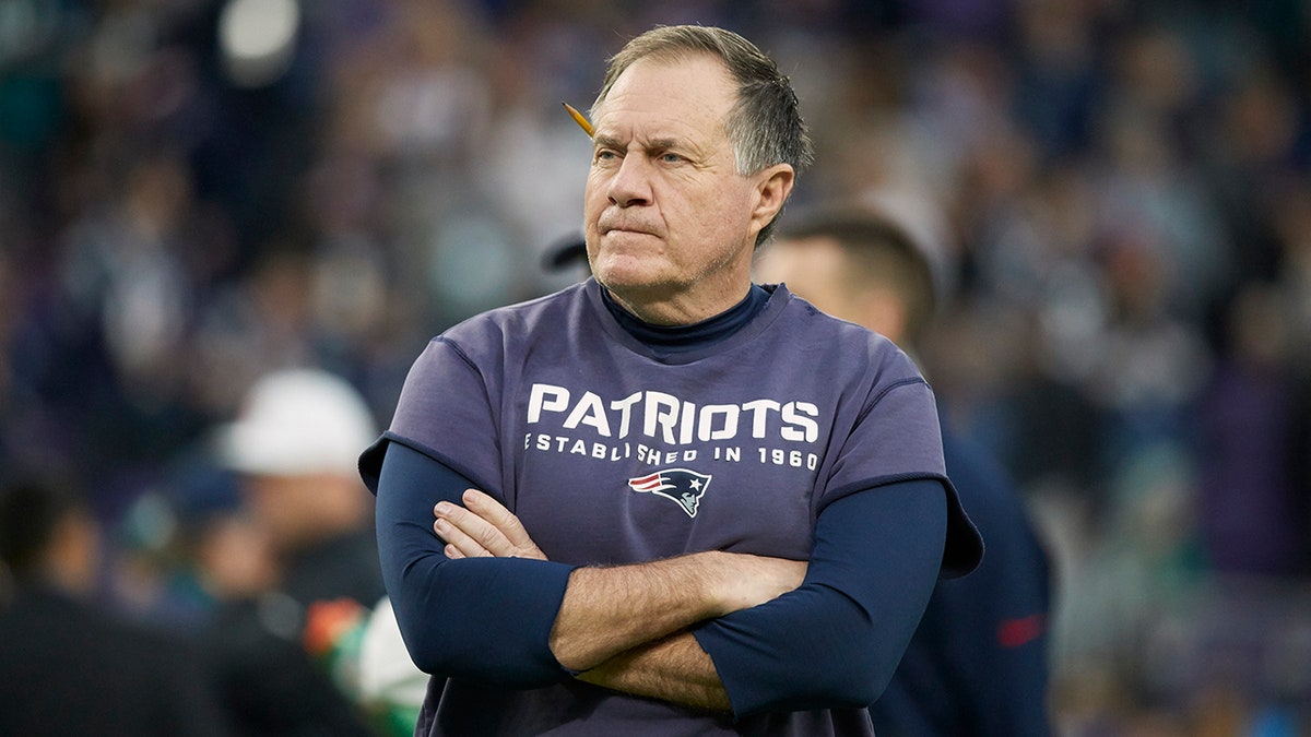 Belichick's arms are folded