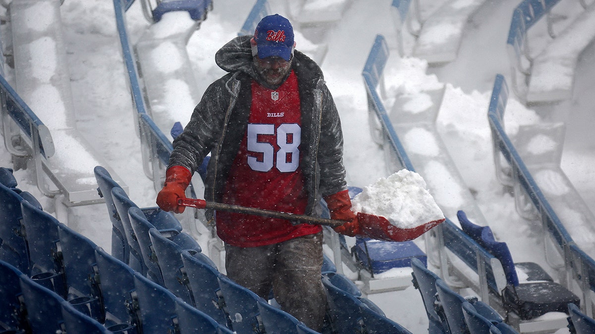 Bills worker shovels snow