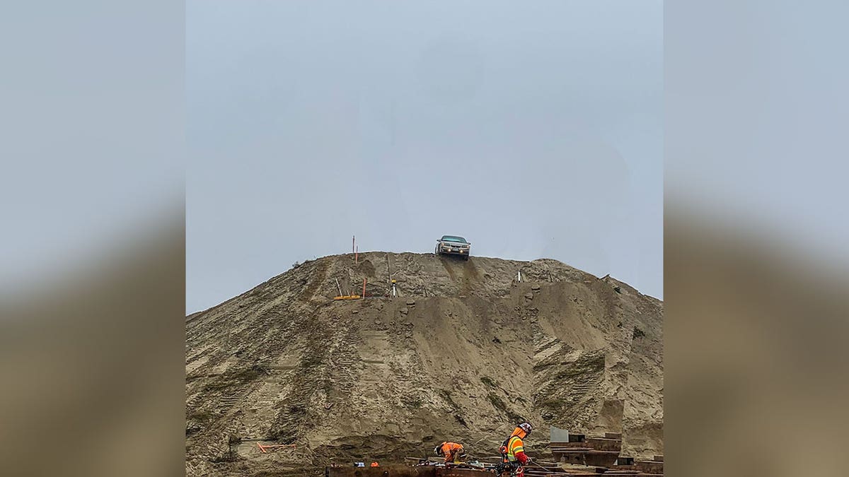 Car on dirt mound