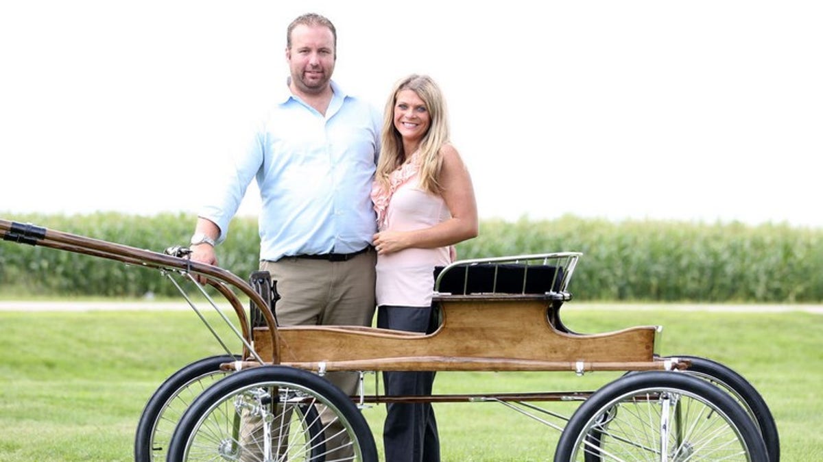 Erik Lee and his wife Shelli stand next to a Fine Harness Buggy.