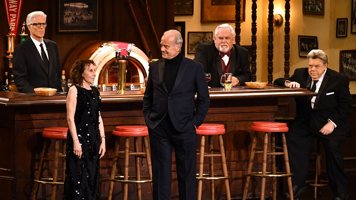 The cast of "Cheers" are scattered around a Bull & Finch Pub on stage at the Emmys