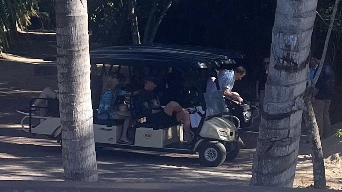 California Gov. Newsom sitting in a golf cart