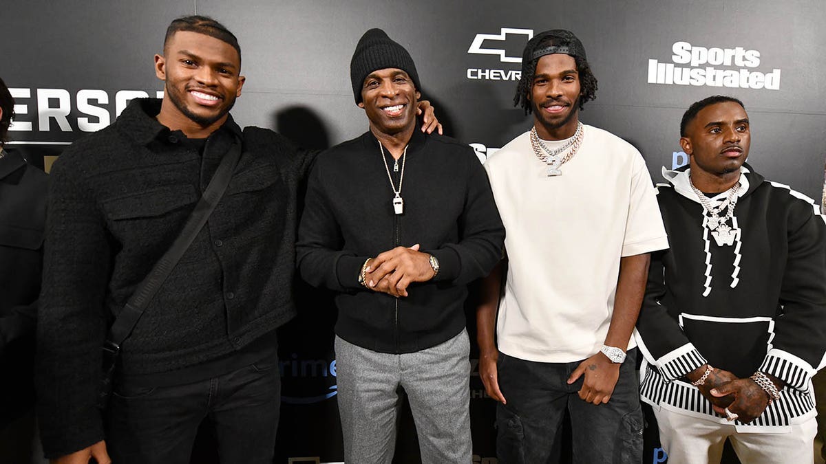 Deion Sanders poses with sons
