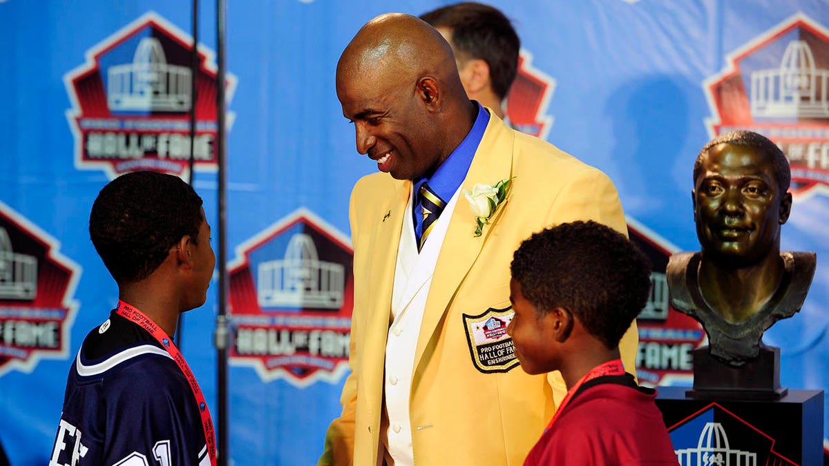 Deion Sanders talks to two of his sons