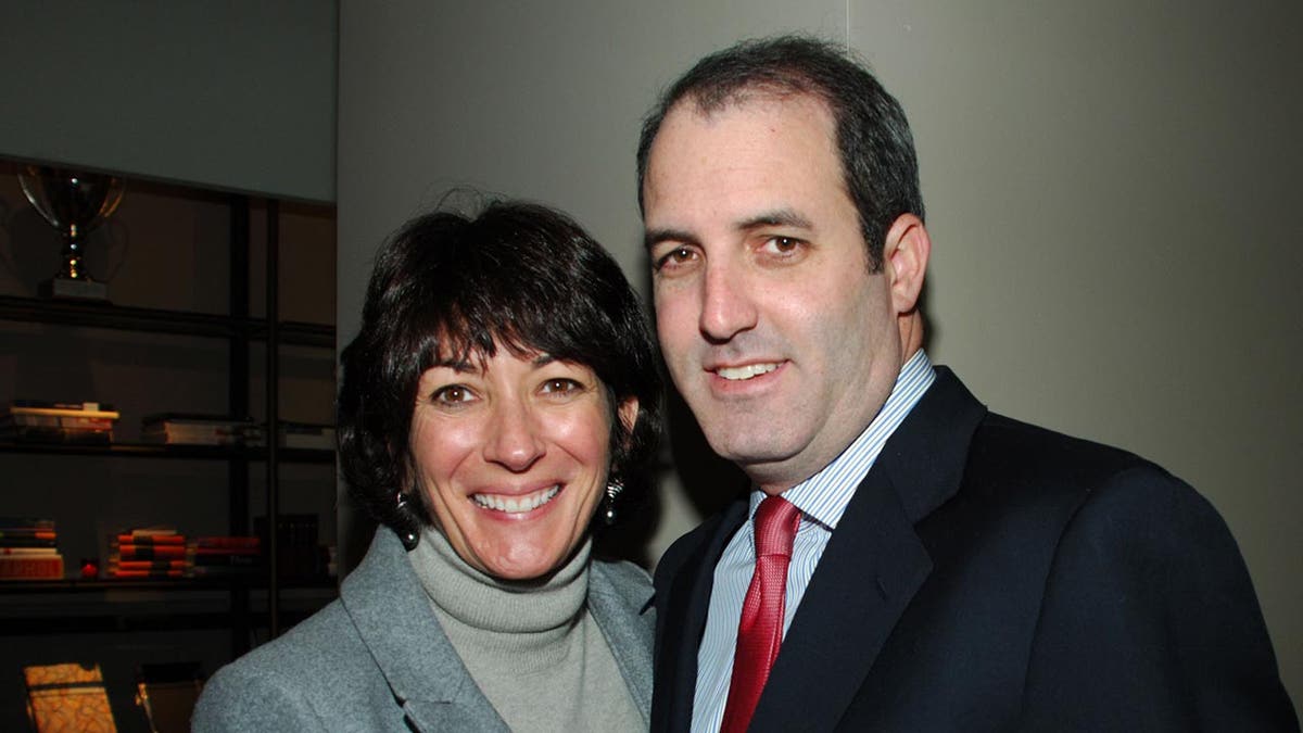 Ghislaine Maxwell and Doug Band standing together at a Valentine's Day tea party in New York City
