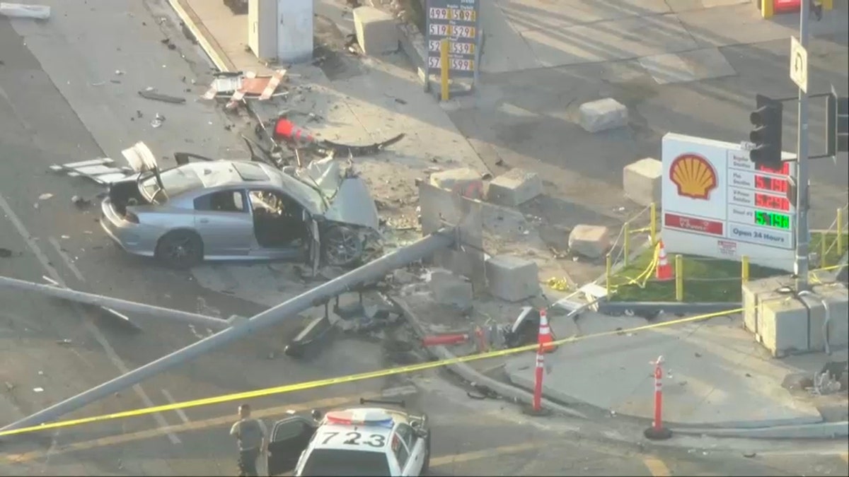 Crash aftermath shows damaged vehicles at intersection