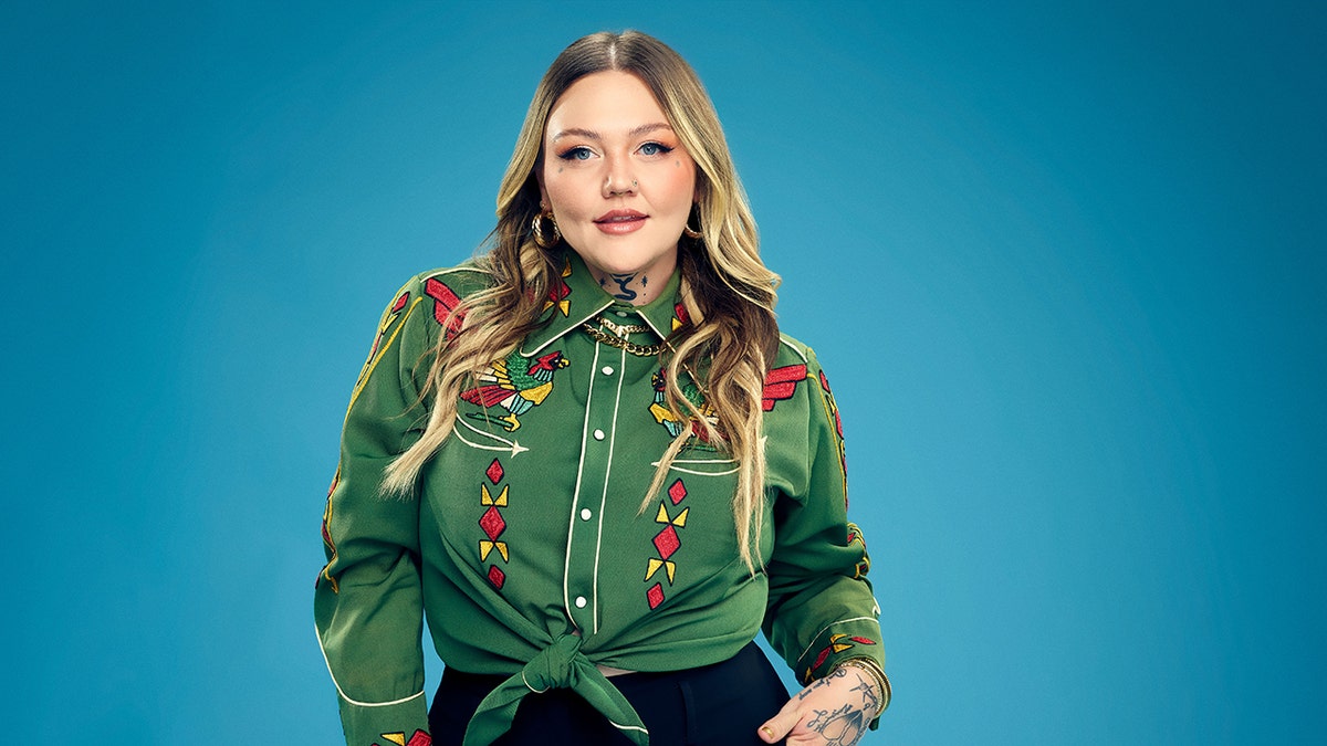 Elle King posing in a country western shirt