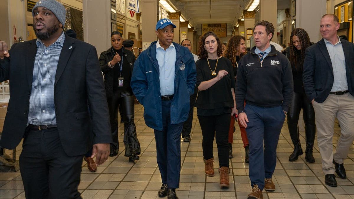 Eric Adams tours a school with staff