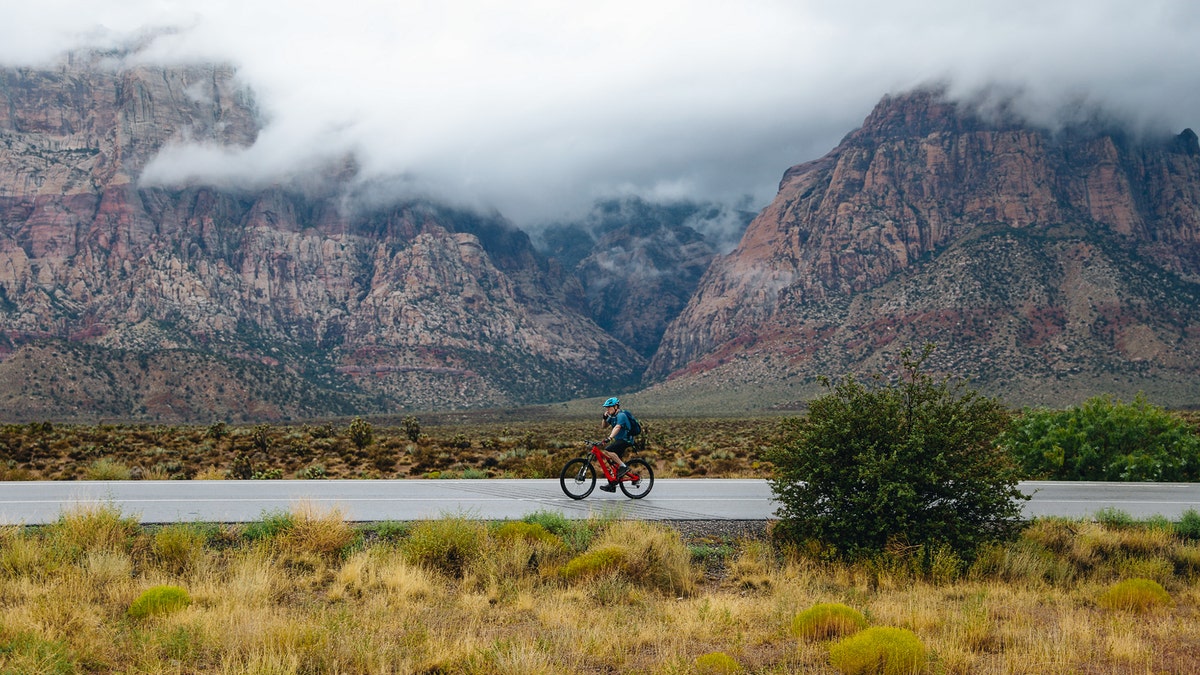 A person riding a bike through Red Rock National Conservation Area