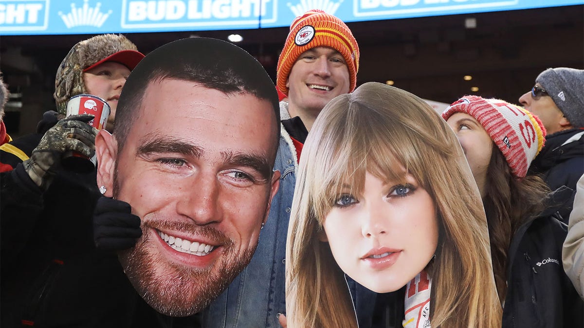 A fan holds posters of Travis Kelce and Taylor Swift