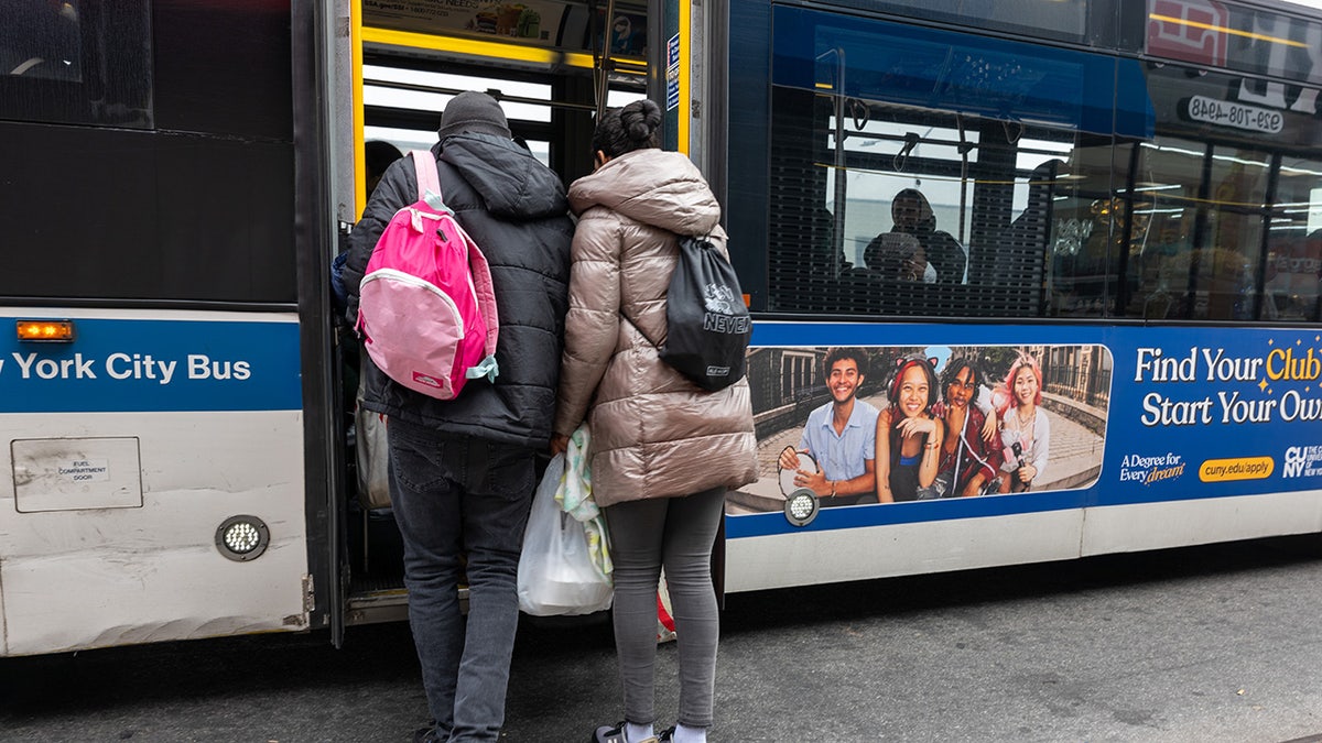 Migrants board NYC bus
