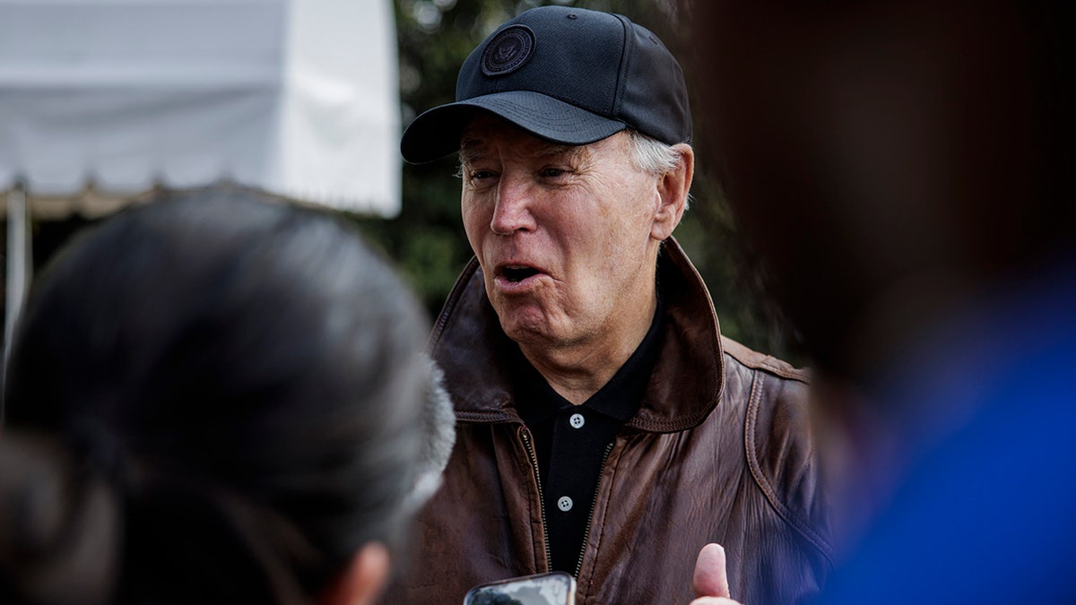 Biden stops to talk to reporters outside the White House