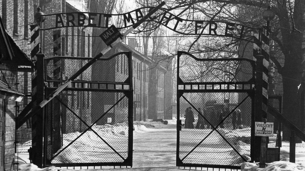 Gates of Auschwitz in black and white photo