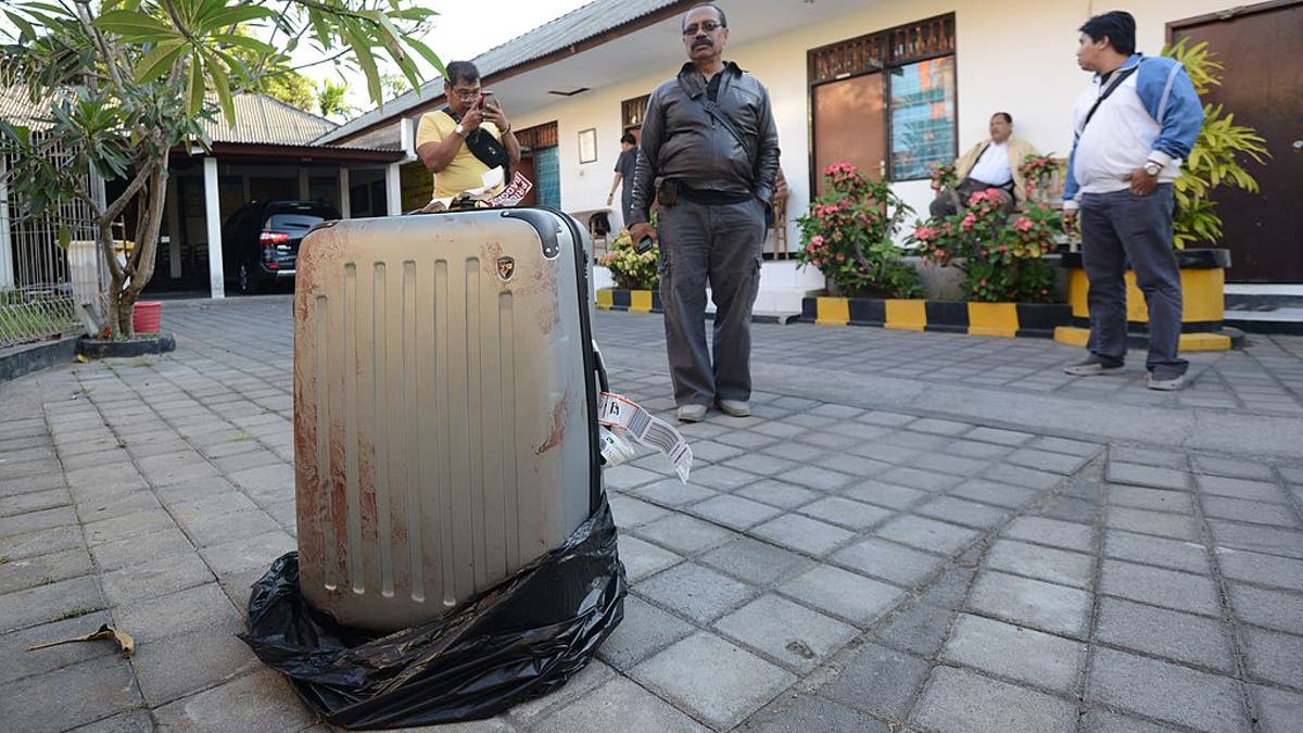 Bloody suitcase in garbage back at St Regis resort in Bali