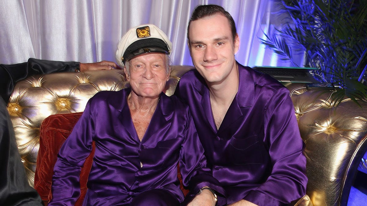 Hugh Hefner and Cooper Hefner wearing matching purple robes