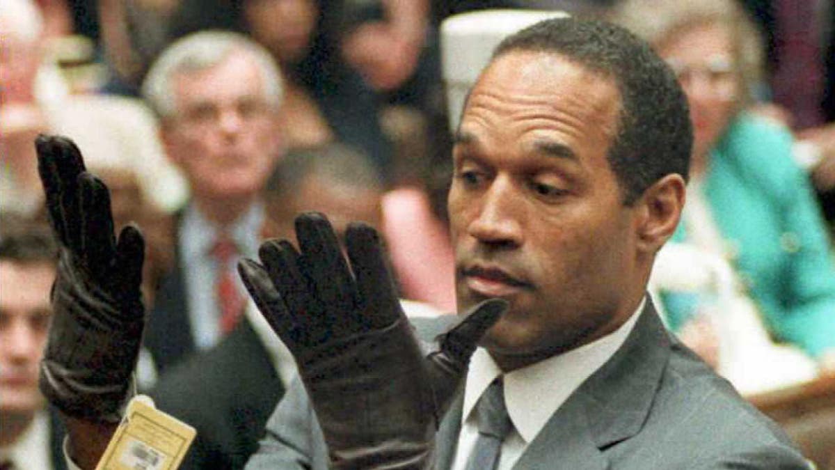 O.J. Simpson looks at a new pair of Aris XL gloves