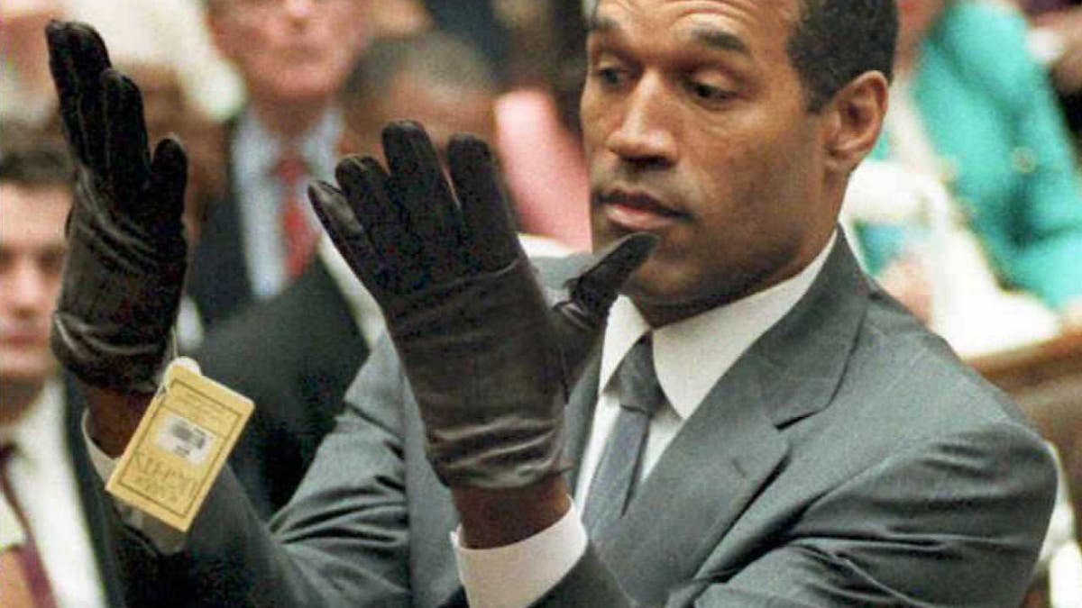 O.J. Simpson looks at a new pair of Aris XL gloves