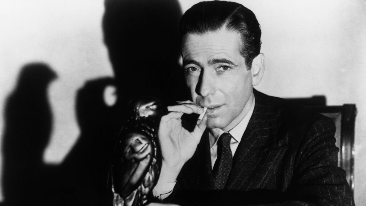 Humphrey Bogart posing with the Maltese Falcon