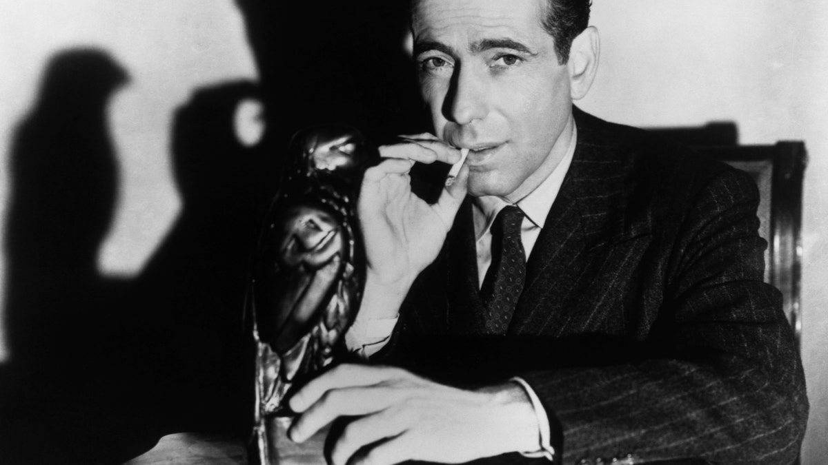 Humphrey Bogart posing with the Maltese Falcon