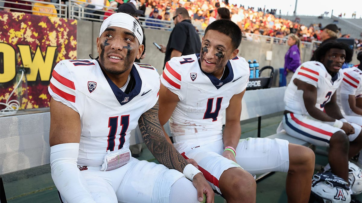 Noah Fifita and Tetairoa McMillan sit on the bench