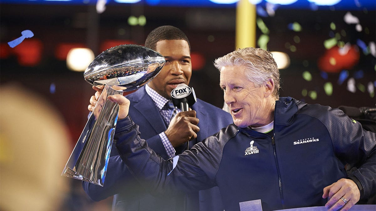 Pete Carroll holding the Super Bowl trophy